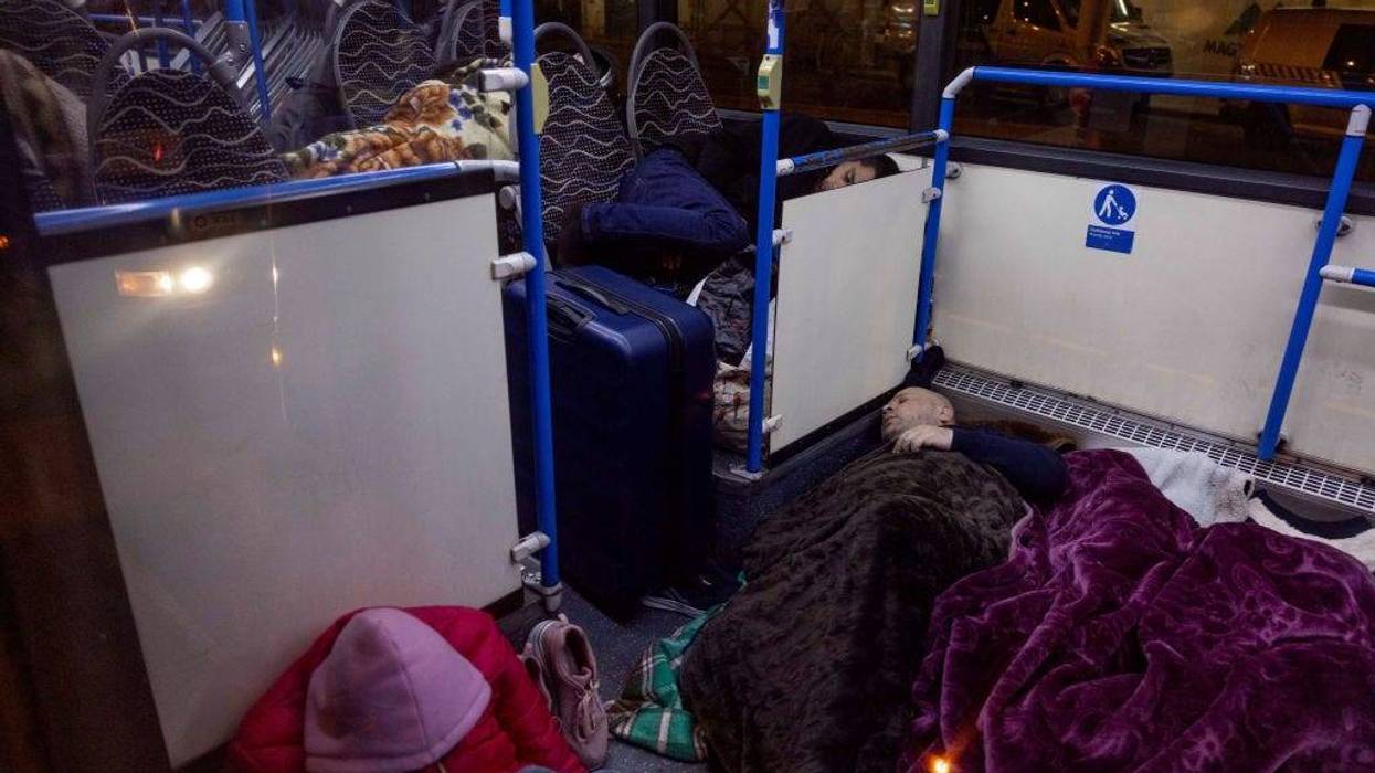 FILE - Ukrainian refugees at the Western Railway Station sleep in warming buses for the night as they flee Ukraine on March 7, 2022 in Budapest, Hungary. Hungary has been the second-most-popular destination for refugees fleeing Ukraine after Russia began a large-scale attack on Feb. 24, 2022.