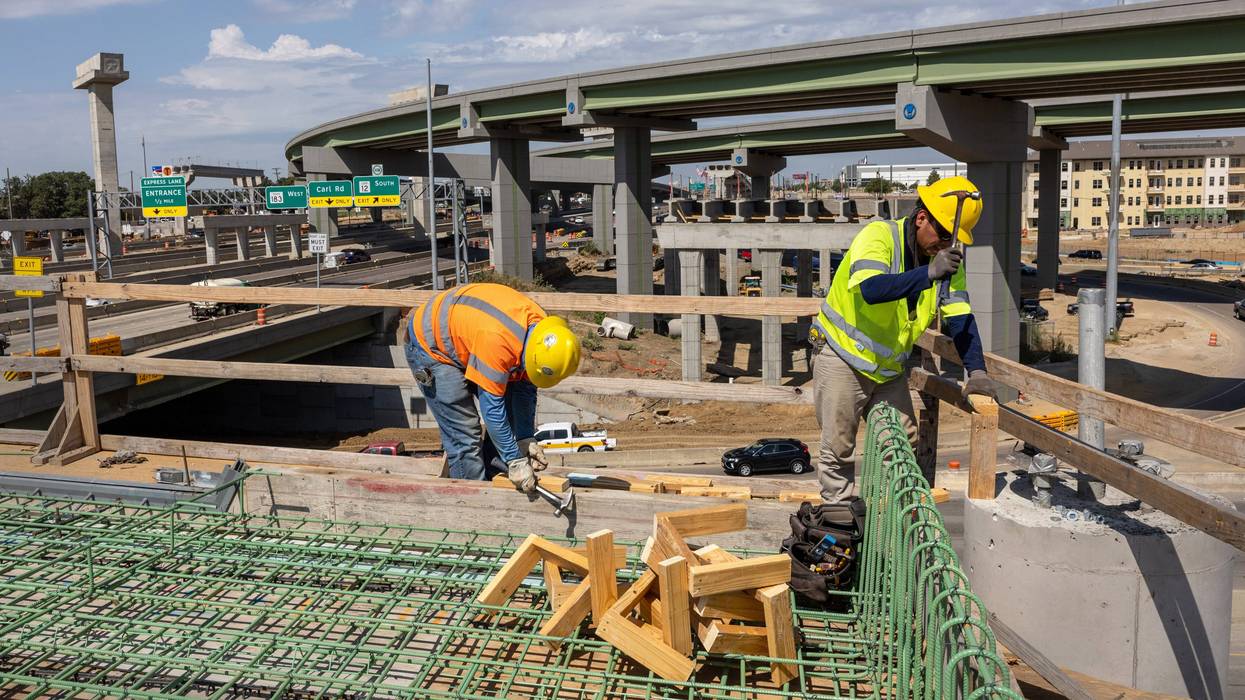 FILE: Workers construct an overpass as part of the Irving Interchange infrastructure project near the site of the former Dallas Cowboys Stadium on Aug. 10, 2022, in Irving, Texas.