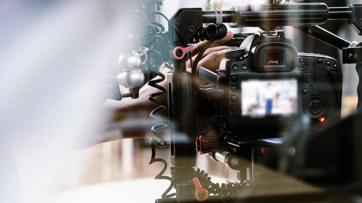 Filming with professional camera background.