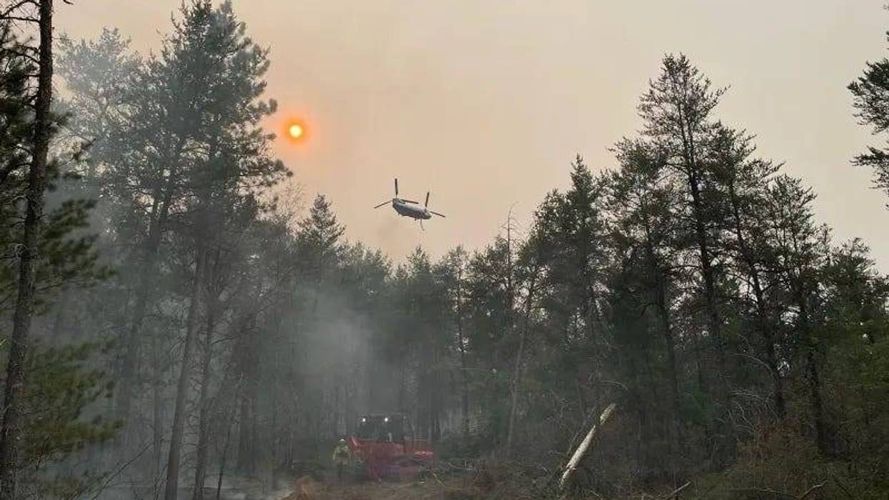 Fire crews battling a wildfire in Northern Michigan are also fighting against windy, dry conditions and warm weather that has allowed the blaze to burn nearly 230 acres.