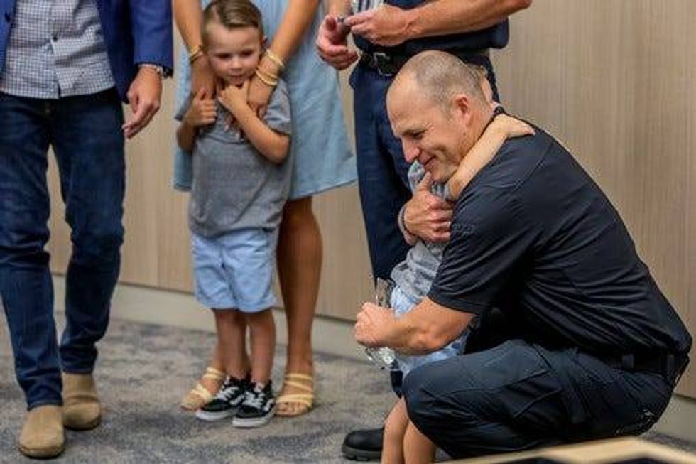 Firefighter hugs four-year-old rescued