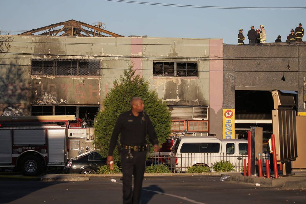 Firefighters and police at the scene of the fire that claimed the lives of 36 people at a warehouse in the Fruitvale neighborhood on December 3, 2016 in Oakland, California.
