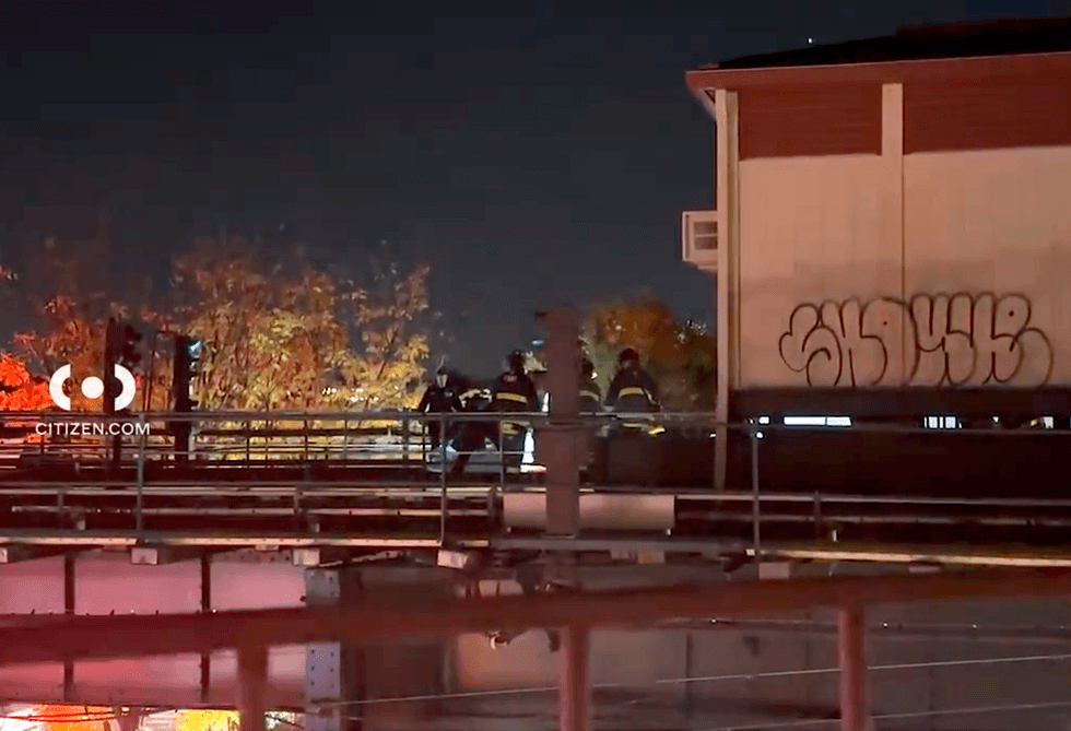 Firefighters are seen on the tracks at the Forest Avenue subway station on Wednesday night