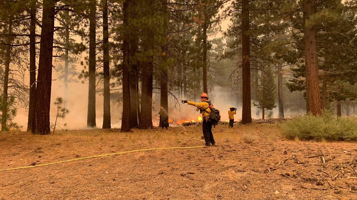 Firefighters battle Caldor Fire flames along Highway 89 in South Lake Tahoe.