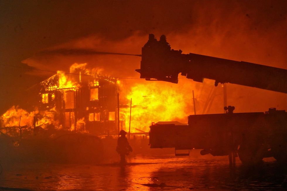 Firefighters battle infernos that destroyed more than 100 homes in Breezy Point, Queens, in the early morning hours of Oct 30, 2012