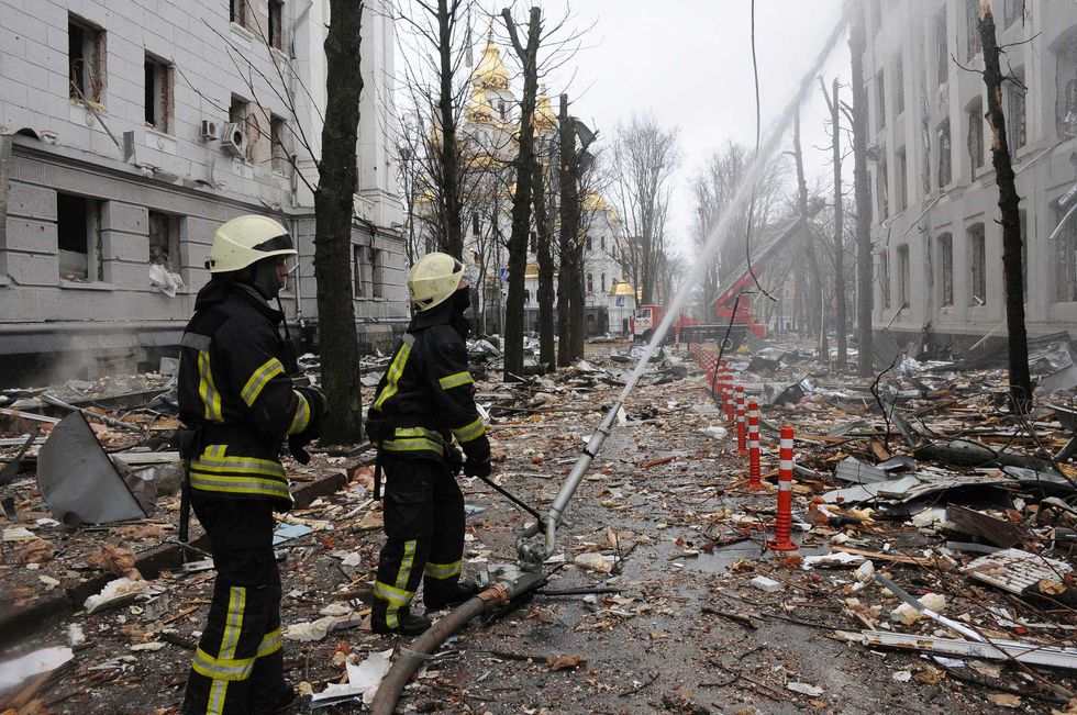 Firefighters extinguish a building of Ukrainian Security Service (SBU) after a rocket attack in Kharkiv, Ukraine