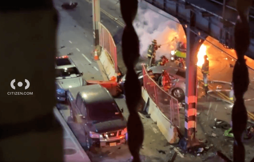 Firefighters extinguish the flames under the 1-line tracks