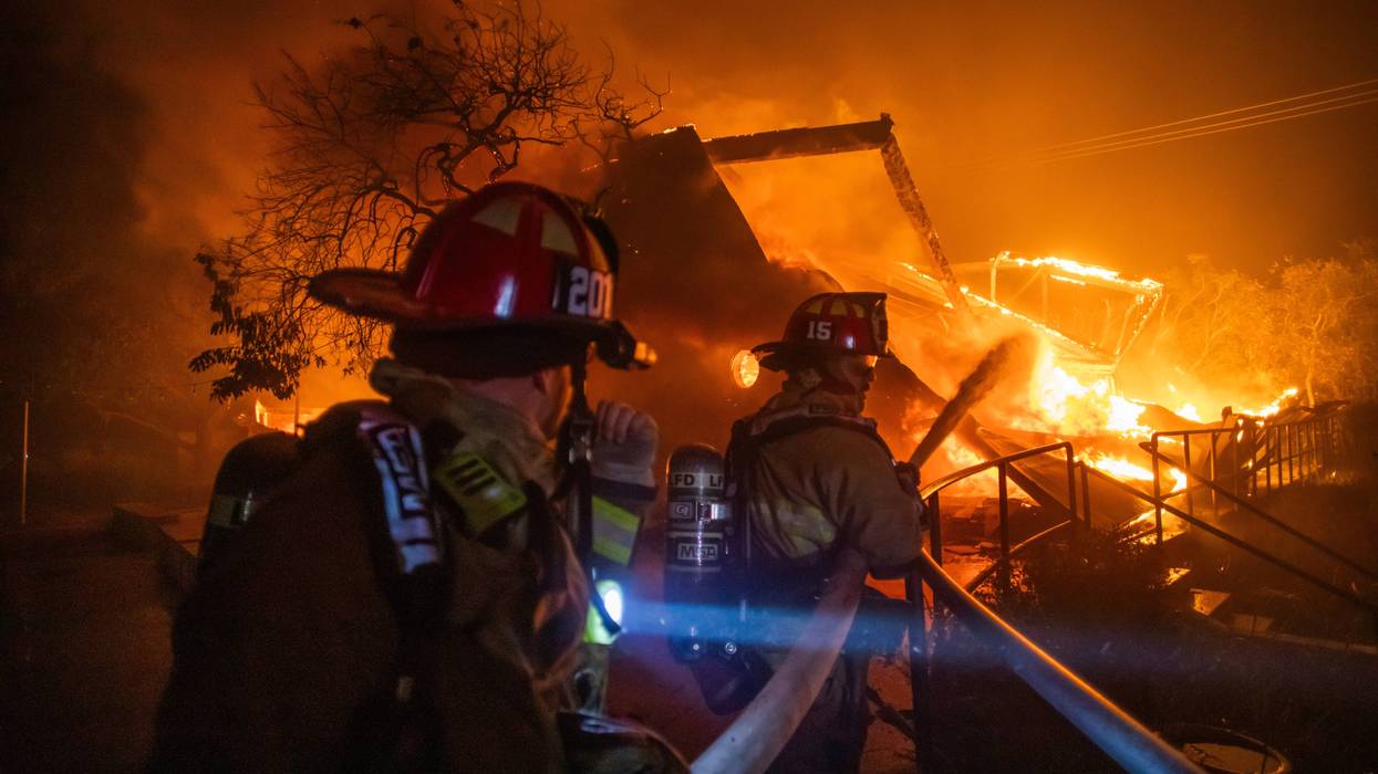 Firefighters fight the flames from the Palisades Fire burning the Theatre Palisades during a powerful windstorm on January 8, 2025/