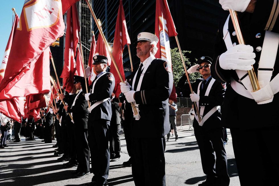 Firefighters gather in lower Manhattan near Ground Zero as the city commemorates the 20th anniversary of the September 11th terrorist attacks on the World Trade Center on September 11, 2021 in New York City