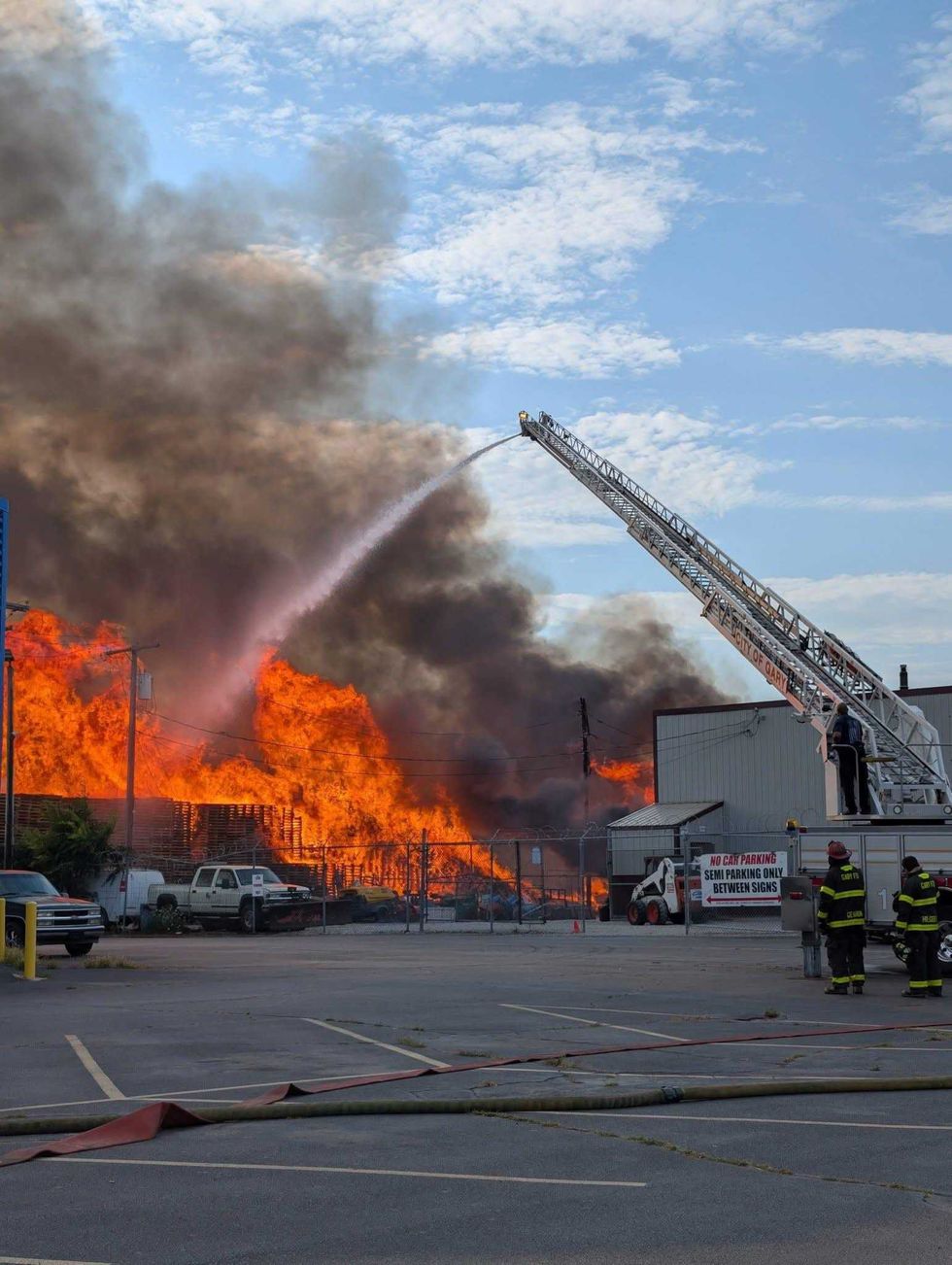 Firefighters in Gary spent more than 18 hours Sunday battling a massive blaze at a pallet company that later reignited, damaging an adjacent property, officials said.