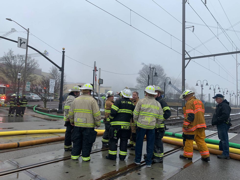 Firefighters outside the site of a fire in Ambler Township on Feb. 3, 2022.