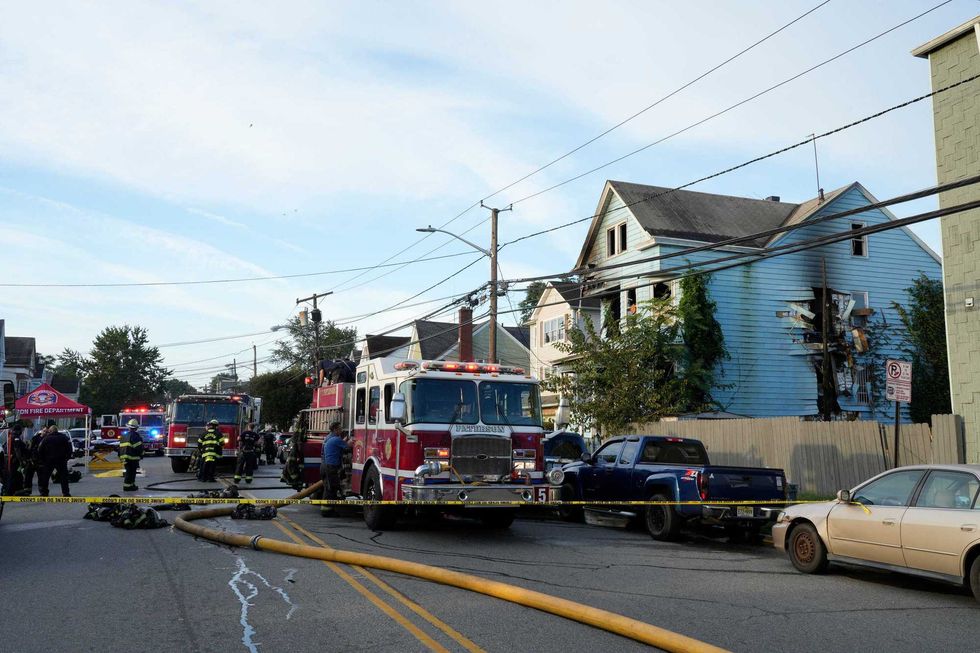 Firefighters respond to the scene of the fire on Madison Avenue on Wednesday. The fire displaced more than a dozen residents.