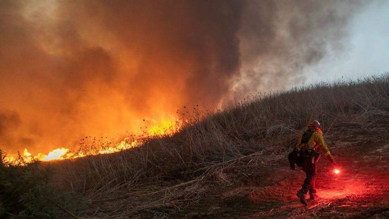 Firefighters set a backfire to protect homes and try to contain the Blue Ridge Fire on October 27, 2020 in Chino Hills, California.