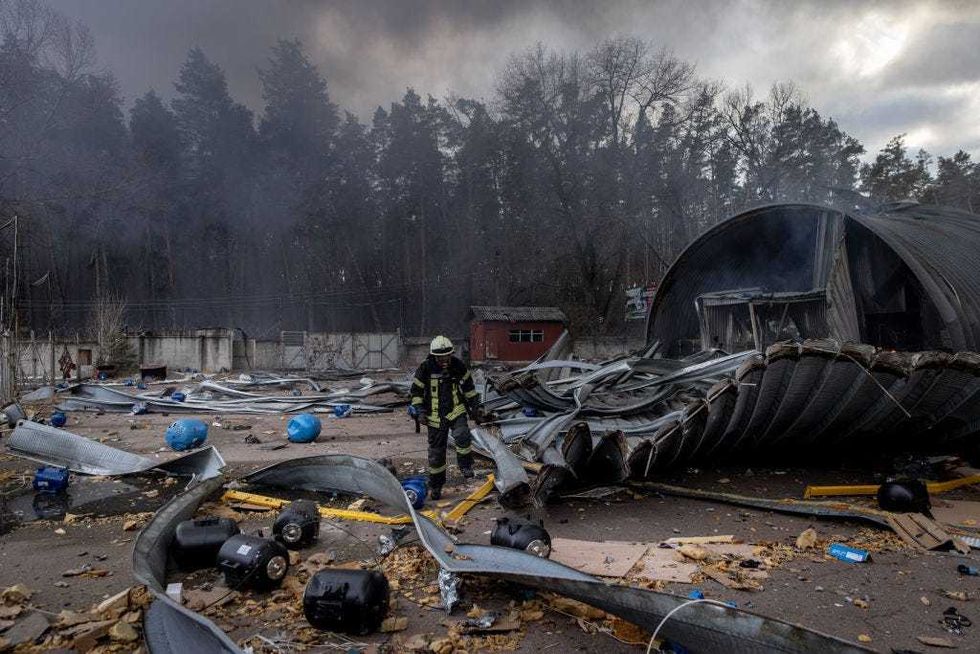 Firefighters try to extinguish a fire after a chemical warehouse was hit by Russian shelling on the eastern frontline near Kalynivka village on March 08, 2022, in Kyiv, Ukraine