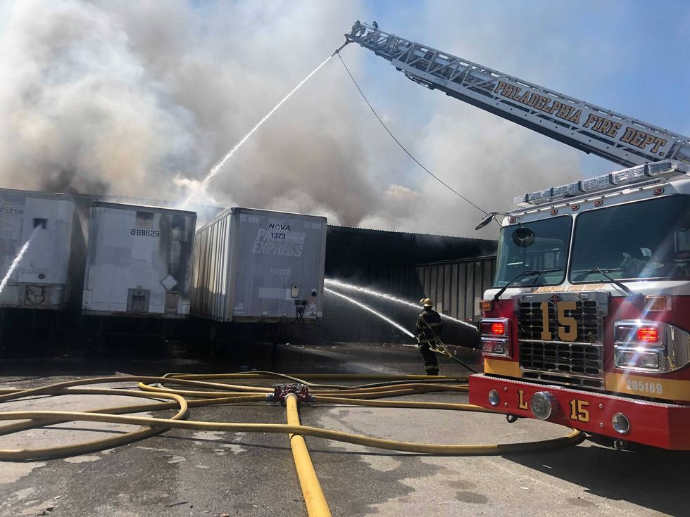 Firefighters work on a warehouse fire in Northeast Philadelphia.