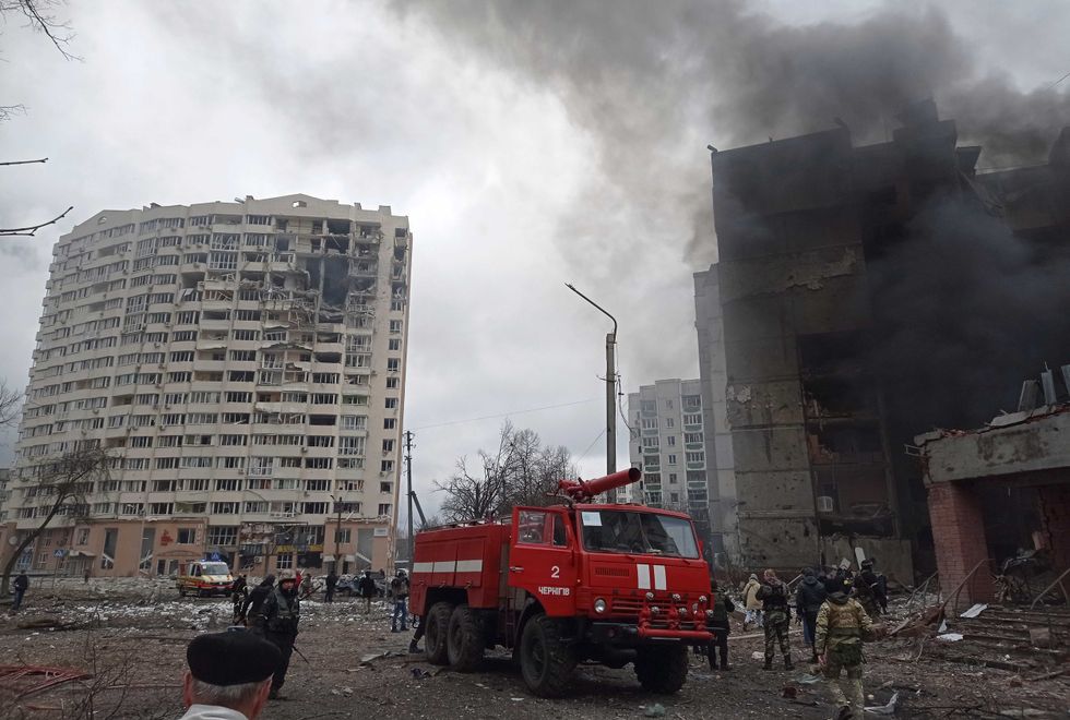 Firefighters work to extinguish a fire at a damaged city center after Russian air raid in Chernigiv, Ukraine, Thursday, March 3, 2022