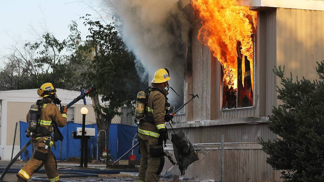 Firefighters work to put out an electrical house fire, the morning after a 7.1 magnitude earthquake struck in the area, on July 6, 2019 in Ridgecrest, California.