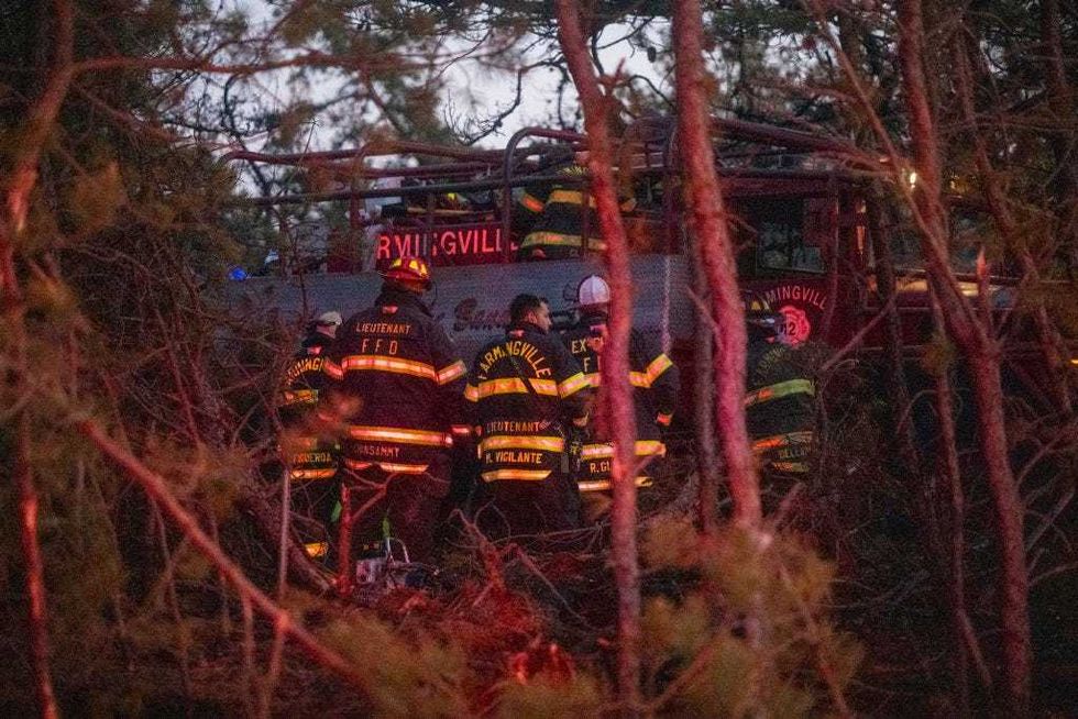 Firefigters assemble around rescue units while putting out fires on March 8, 2025 in Westhampton, New York.