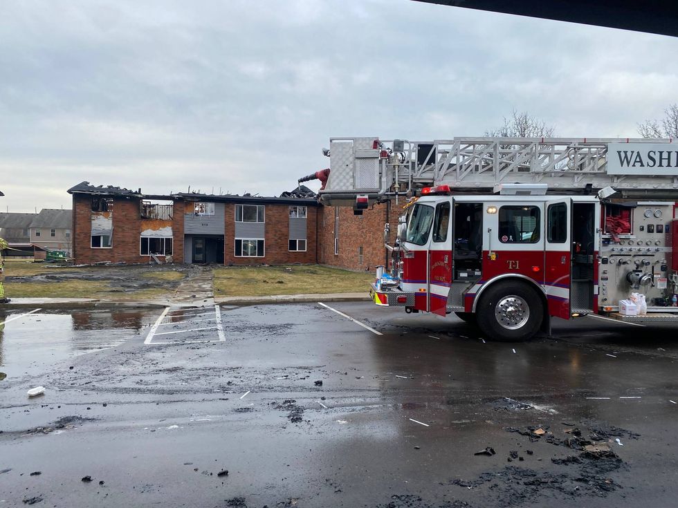Firetruck in front of burnt building