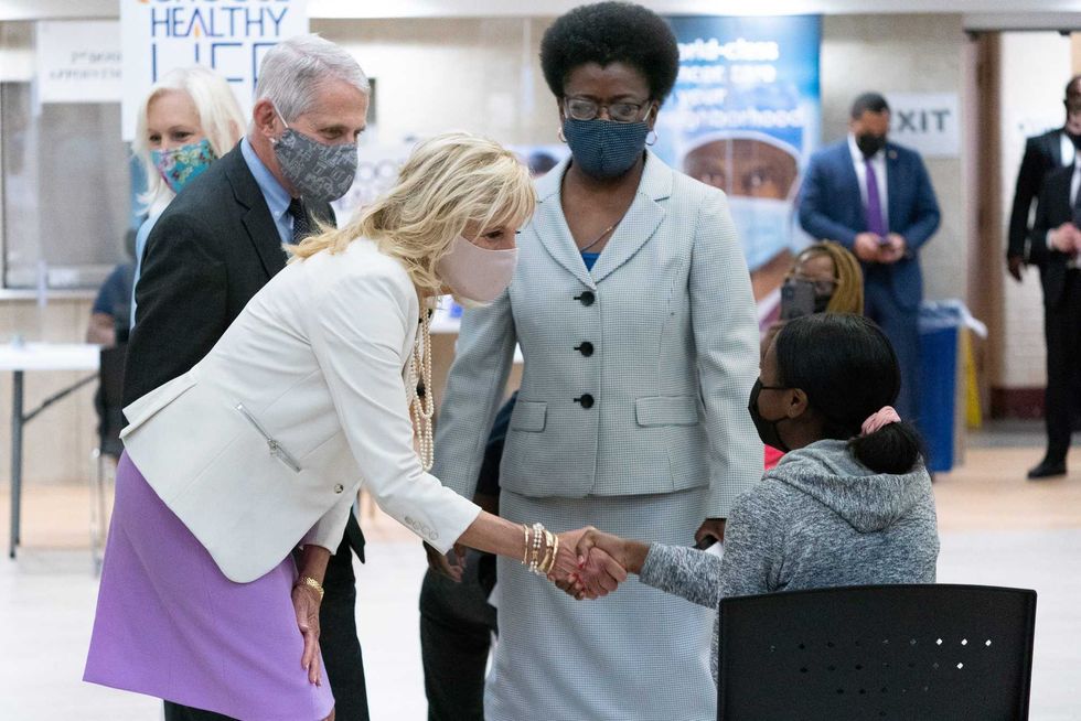 First Lady Dr. Jill Biden (C) and Dr. Anthony Fauci (L), Director of the National Institute of Allergy and Infectious Diseases, speaks with a person getting vaccinated at Abyssinian Baptist Church on June 6, 2021 in New York City