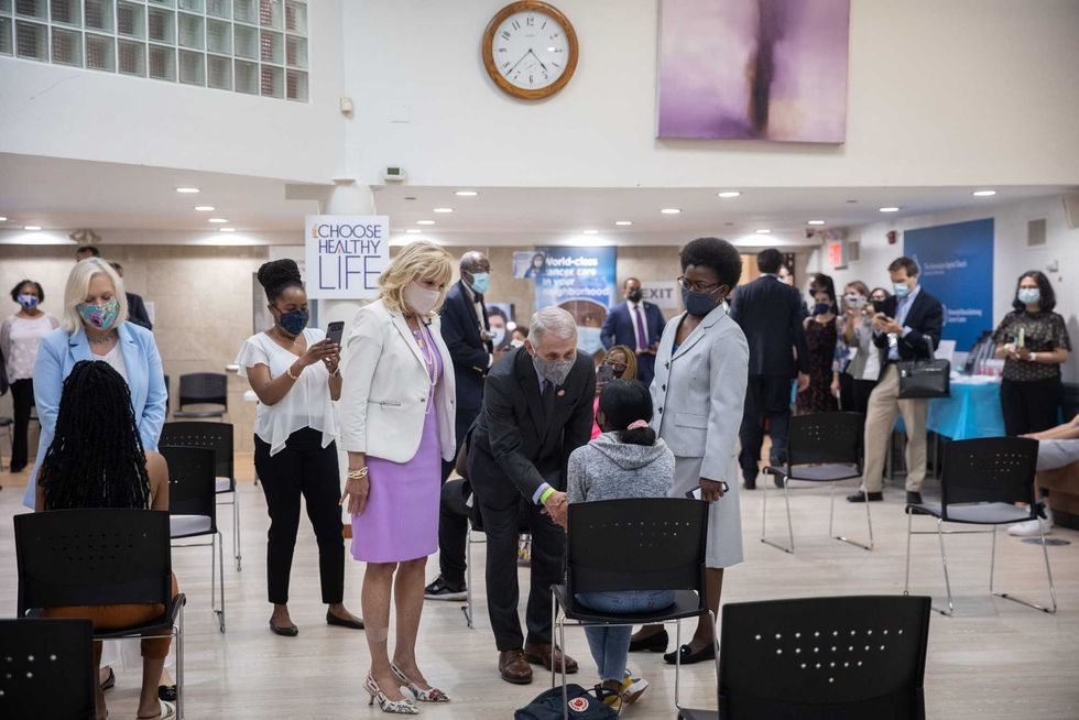 First Lady Dr. Jill Biden (L) and Dr. Anthony Fauci (C), Director of the National Institute of Allergy and Infectious Diseases, speak with a person getting vaccinated at Abyssinian Baptist Church on June 6, 2021 in New York City