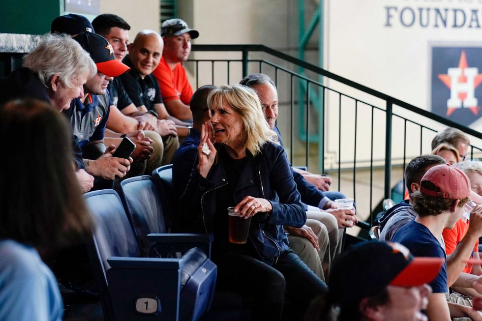 First lady Jill Biden and Second Gentleman Doug Emhoff sit with military members and first responders as they attend a baseball game between the Houston Astros and the Baltimore Orioles at Minute Maid Park, in Houston, Texas, on June 29, 2021.