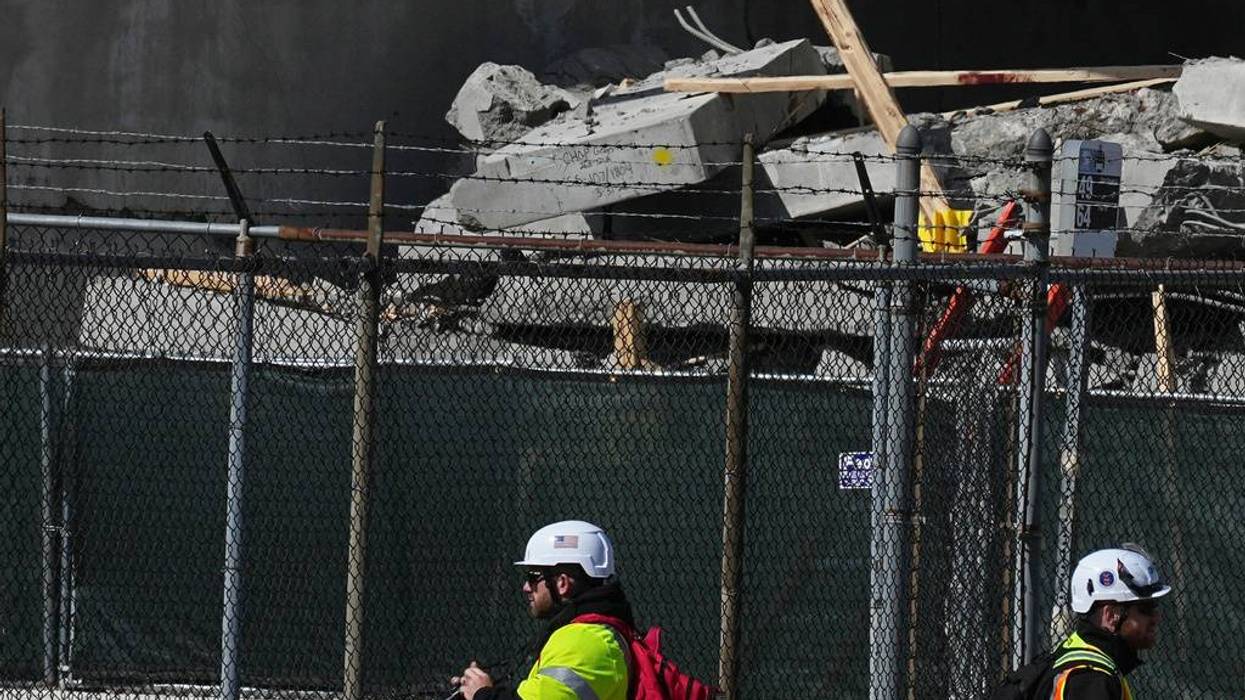First responders inspect a partially collapsed parking garage in Philadelphia, Thursday, April 9, 2026.