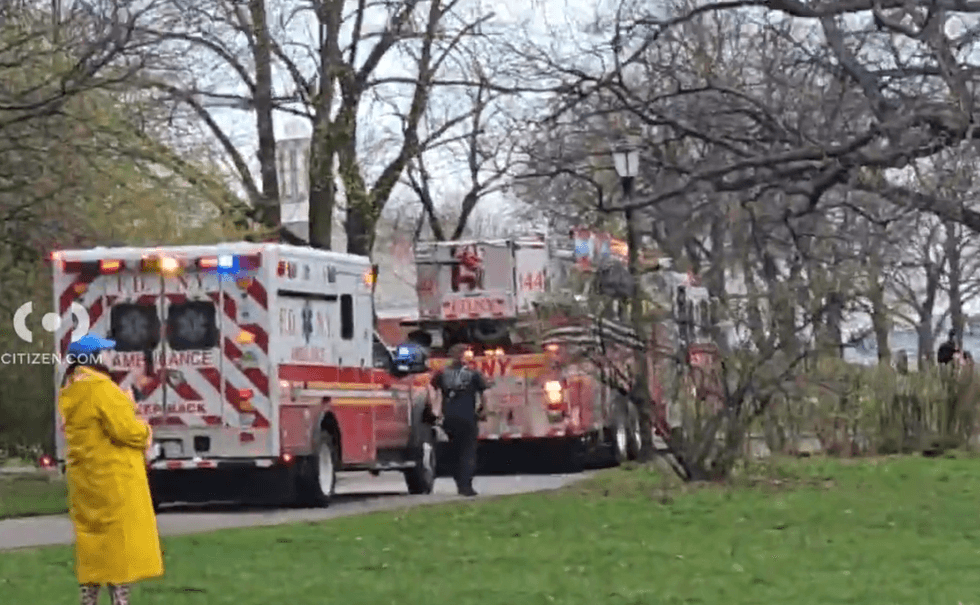 First responders on the shore near where four people were rescued from the East River after their boat capsized on Sunday afternoon.