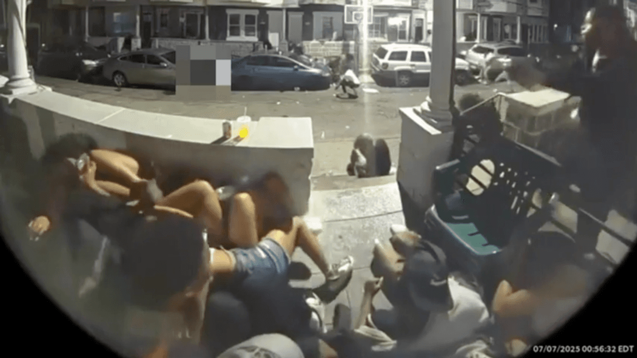 Fisheye view of a chaotic street scene with multiple people fallen on the ground and surrounding structures.