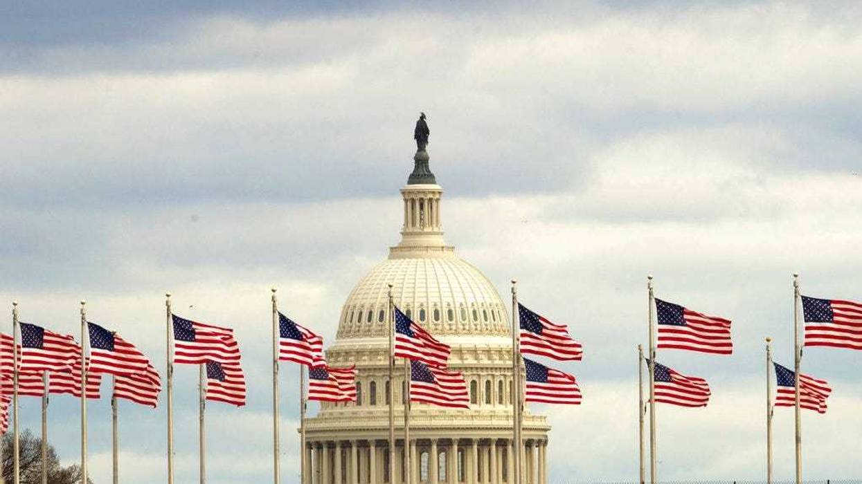 Flags fly in front of the U.S. Capitol in Washington, Tuesday morning, Jan. 1, 2019, as a partial government shutdown stretches into its third week