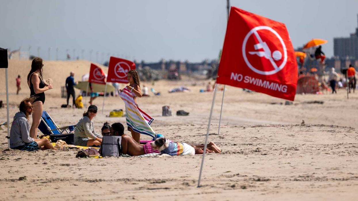 Flags warn that the beach is closed to swimmers at Rockaway Beach in New York.