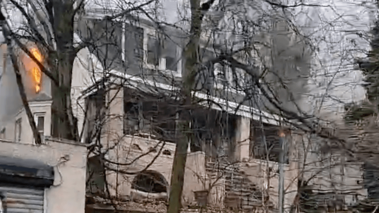 Flames could be seen shooting out of the three-story home during Friday's blaze.