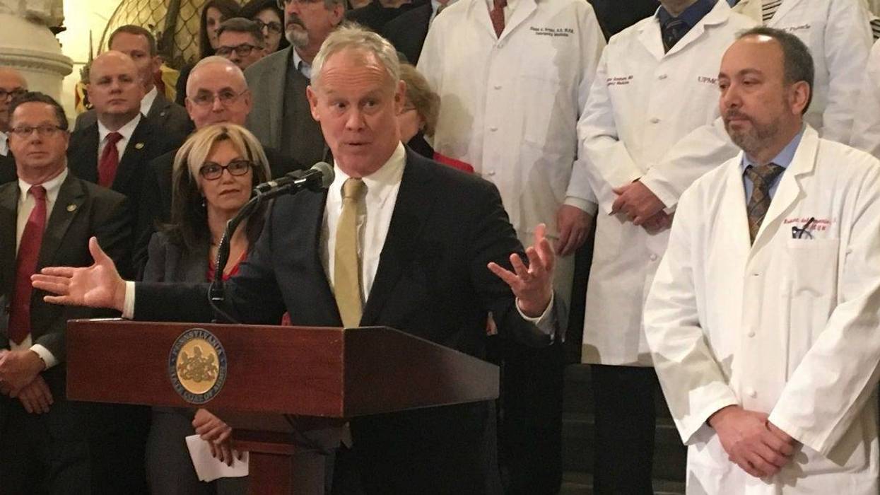 Flanked by doctors, Pa. House Speaker Mike Turzai speaks at the Capitol in Harrisburg.