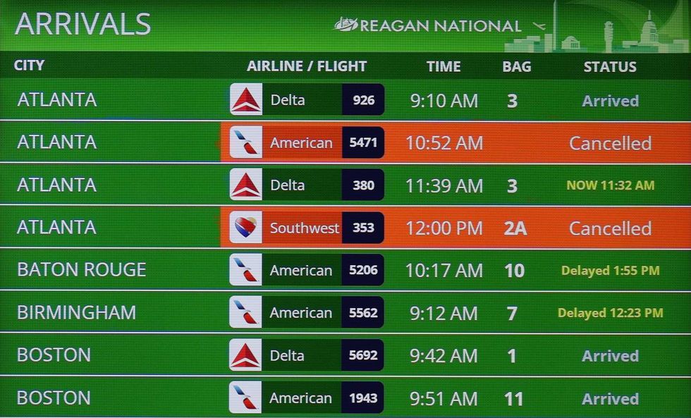Flight cancellations are shown on a bulletin board at Ronald Reagan Washington National Airport on November 11, 2025 in Arlington, Virginia.
