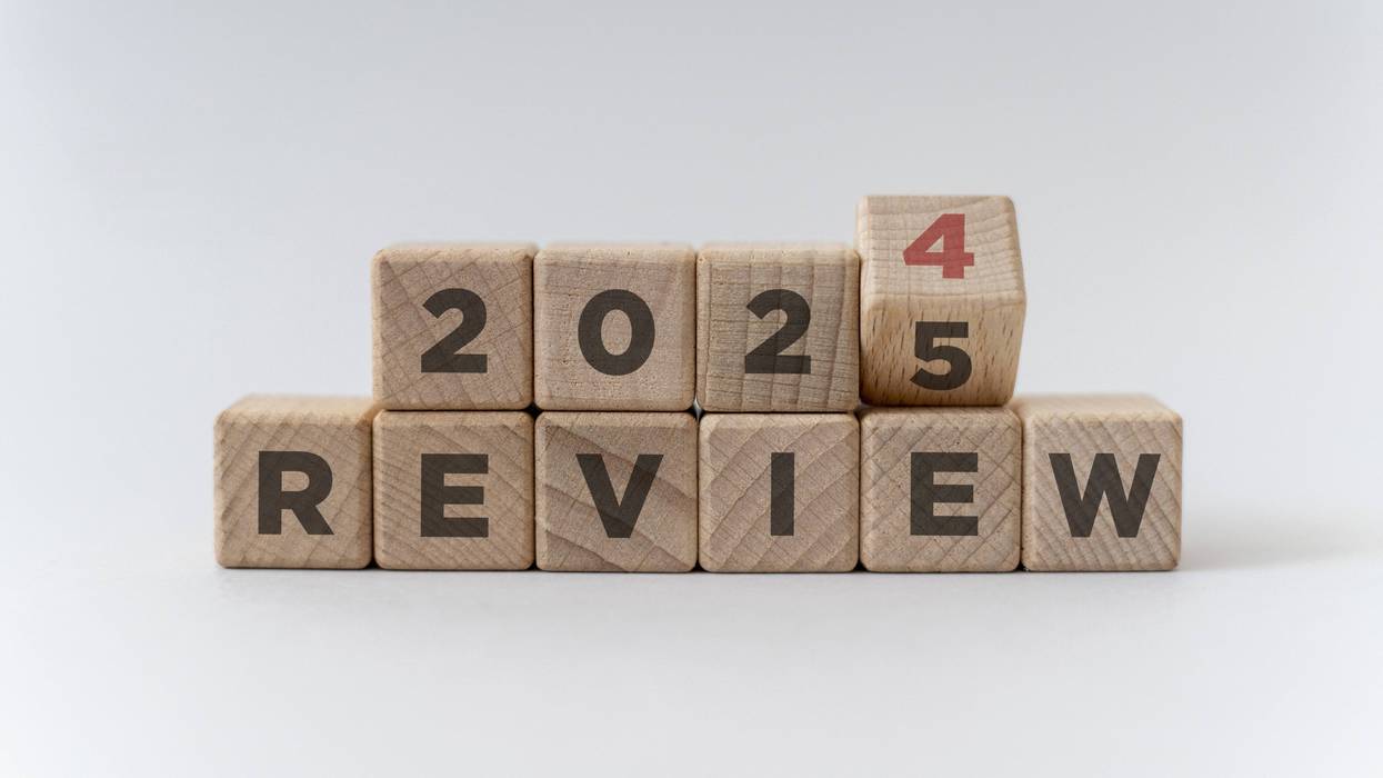 Flipping of 2024 to 2025 on wooden blocks that read "review".
