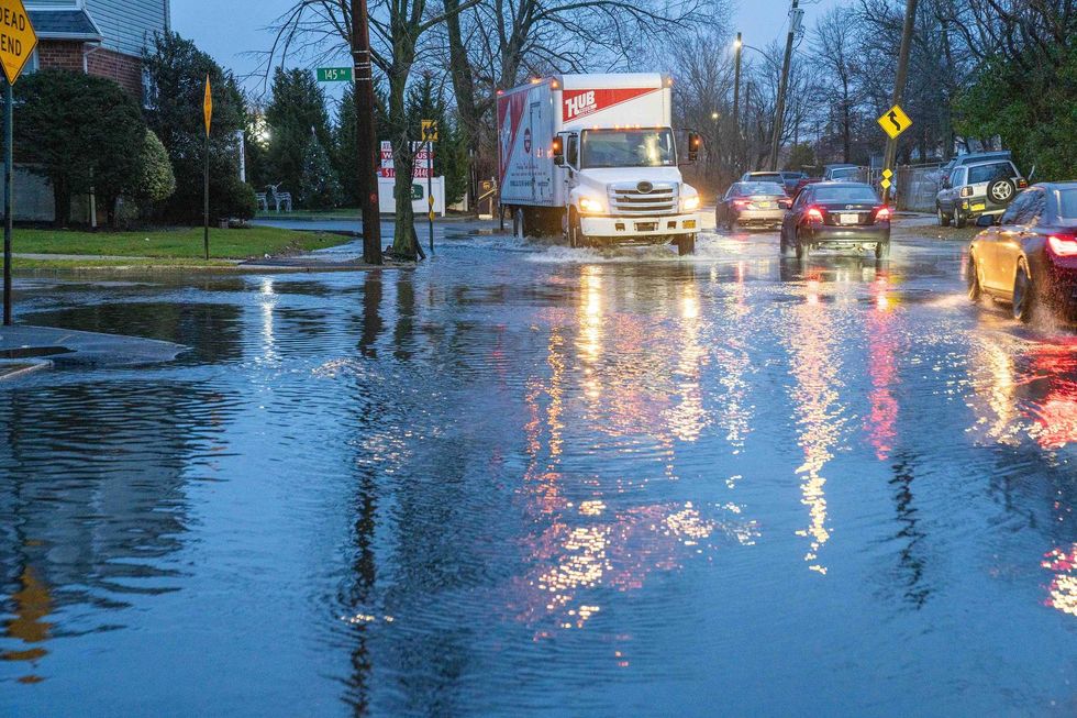 Floodwaters block the intersection of Hook Creek Boulevard at 145th Avenue in Rosedale, Queens, on Dec. 18, 2023