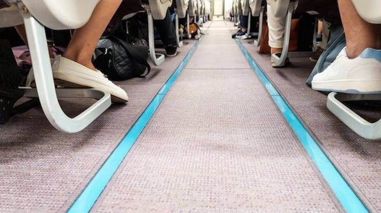 Floor of an airplane cabin with passengers in seats