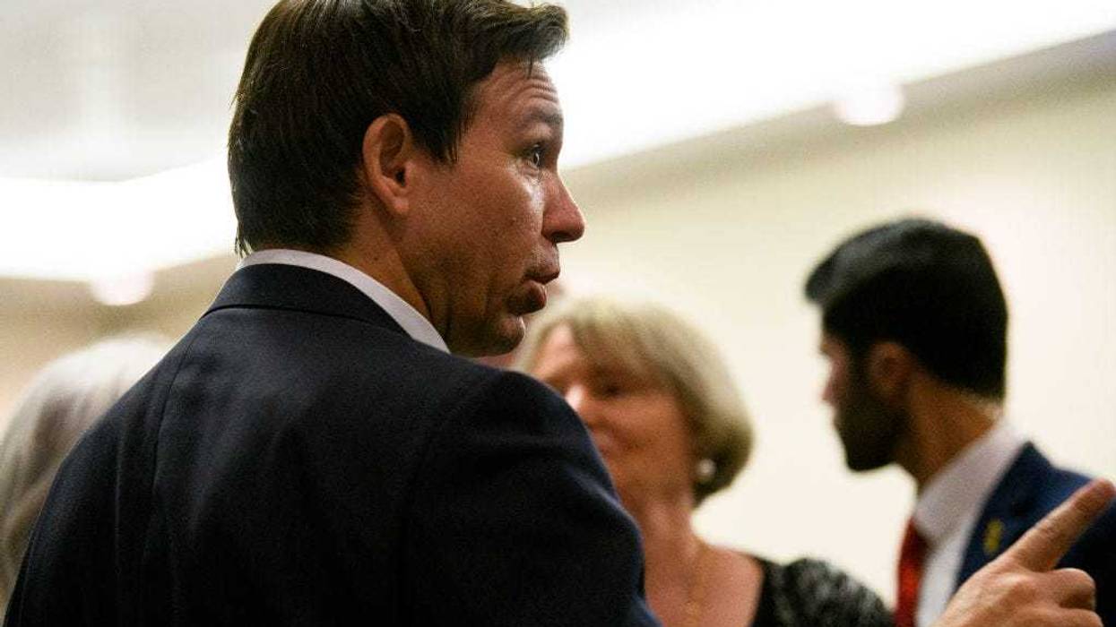 Florida Gov. Ron DeSantis speaks with attendees during an Iowa GOP reception on May 13, 2023 in Cedar Rapids, Iowa.
