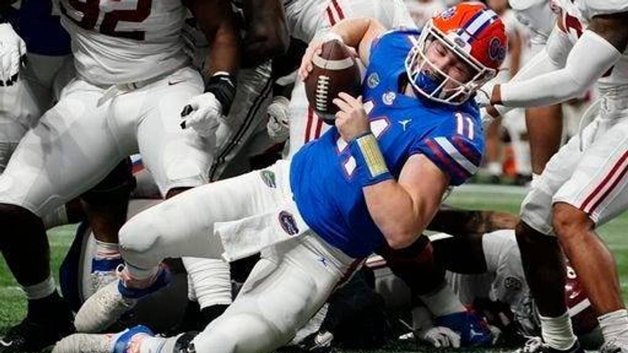 Florida quarterback Kyle Trask (11) leaps into the end zone for a touchdown against Alabama during the first half of the Southeastern Conference championship NCAA college football game, Saturday, Dec. 19, 2020, in Atlanta.