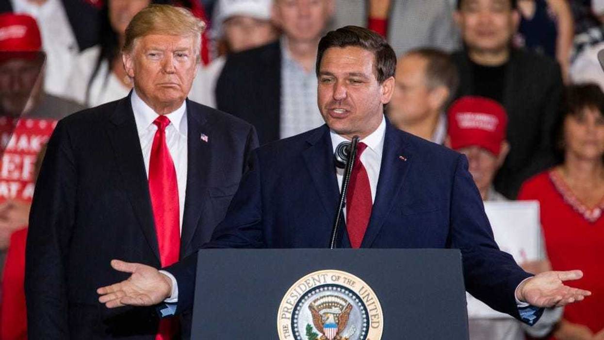 Florida Republican gubernatorial candidate Ron DeSantis speaks with U.S. President Donald Trump at a campaign rally at the Pensacola International Airport on November 3, 2018 in Pensacola, Florida.