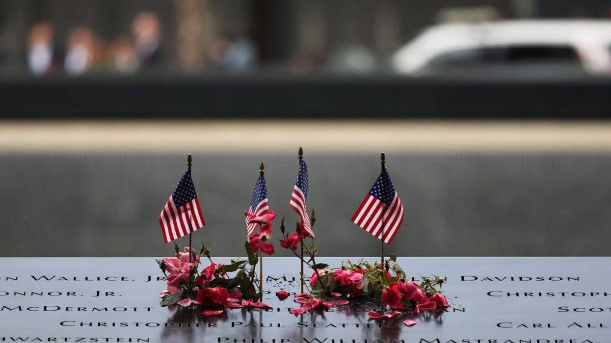 Flowers and flags are seen on the names of the victims of the 9/11 terror attack at the North Tower Memorial Pool during the annual 9/11 Commemoration Ceremony at the National 9/11 Memorial and Museum on September 11, 2023 in New York City.