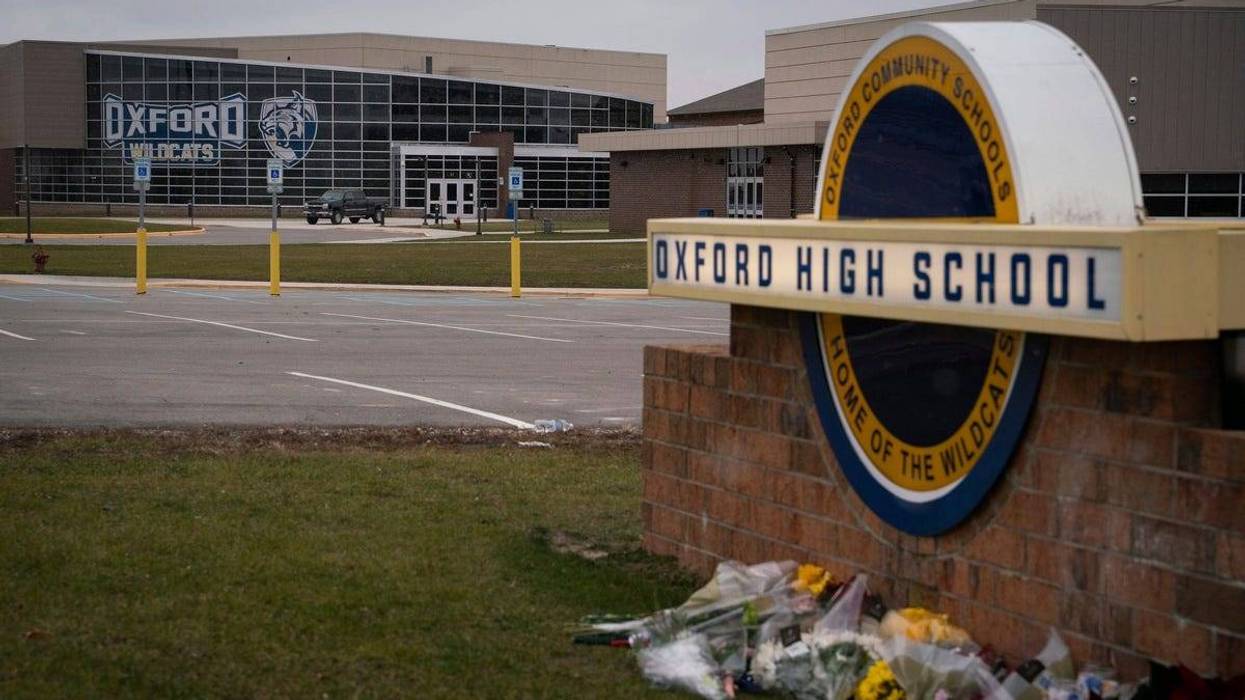Flowers are left by members of the community to honor the one-year anniversary of the Oxford shooting outside of Oxford High School on Wednesday, Nov. 30, 2022.