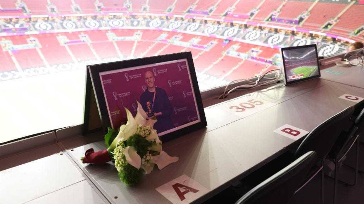 Flowers are placed in memory of Grant Wahl, an American sports journalist who passed away whilst reporting on the Argentina and Netherlands match, prior to the FIFA World Cup Qatar 2022 quarter final match between England and France at Al Bayt Stadium on December 10, 2022 in Al Khor, Qatar. (Photo by Clive Brunskill/Getty Images)