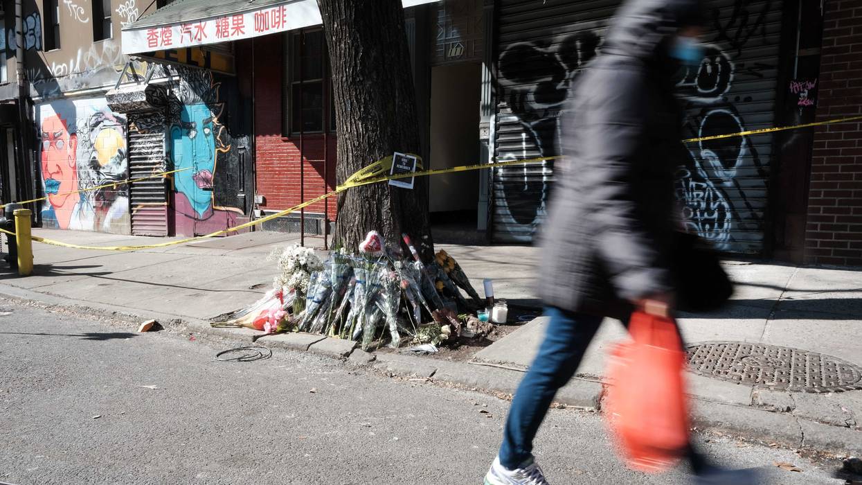 Flowers are set outside of the building where Christina Yuna Lee was murdered in the early hours of Feb. 13, allegedly by a man who followed her into her Chrystie Street apartment