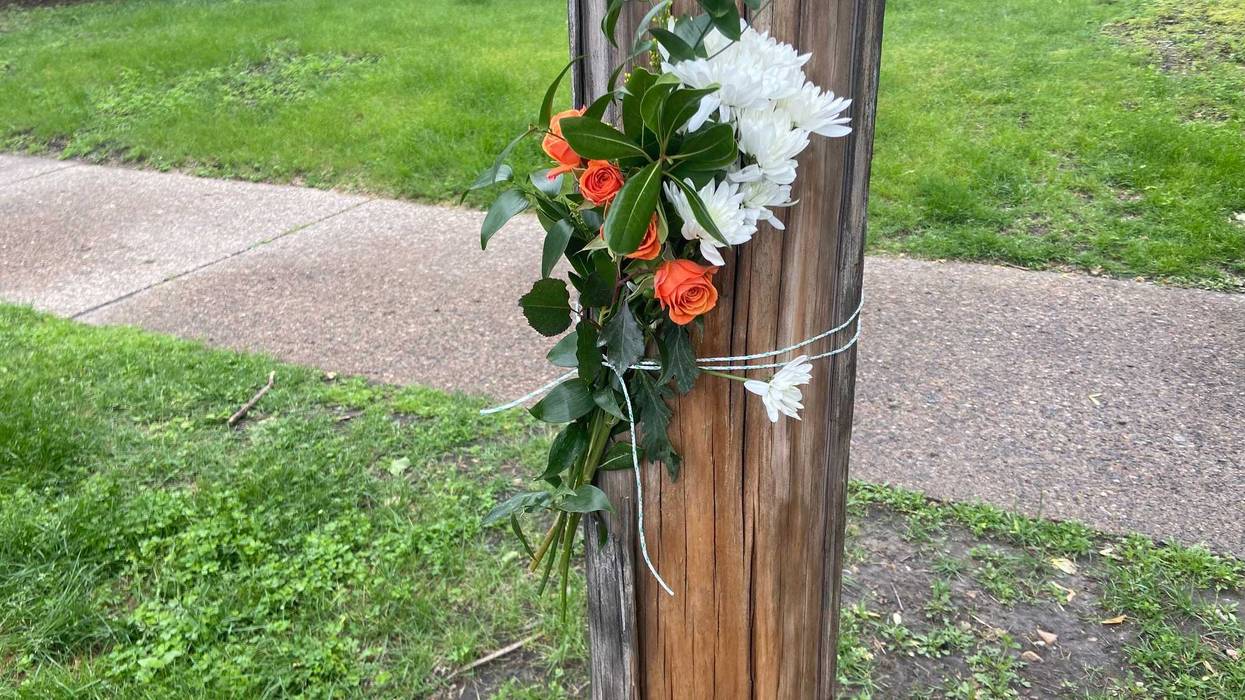 Flowers near 22nd and Blaisdell remember the victims of Thursday night's shooting in South Minneapolis.