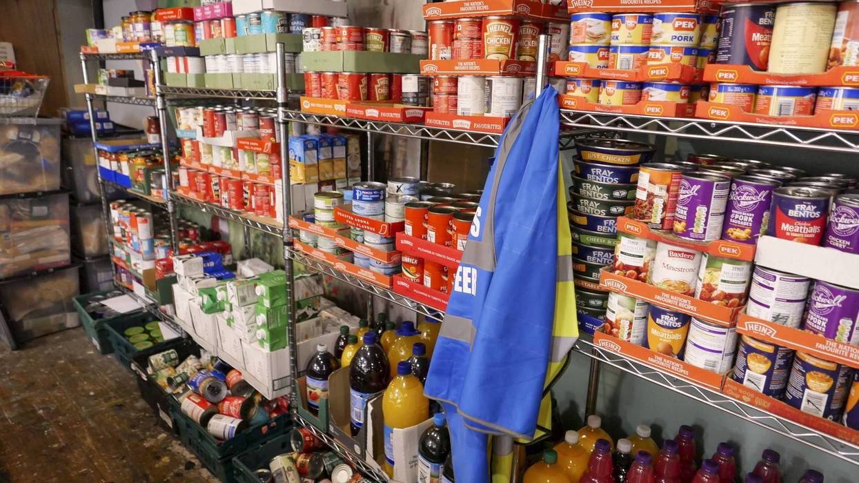 Food bank shelving filled with donated tinned food ready for distribution