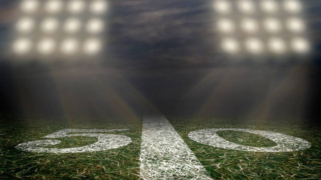 Football field under Friday night lights