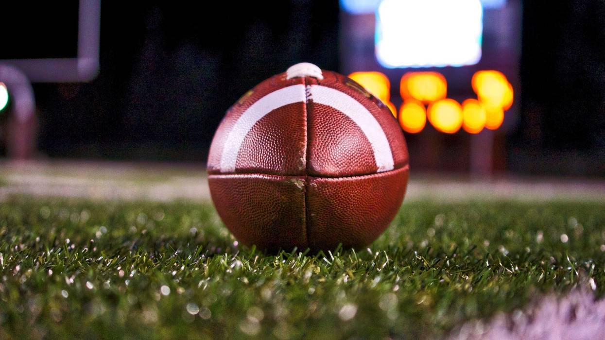 Football on a field at night