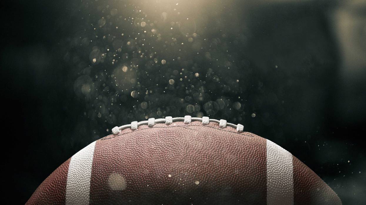 Football on black background illuminated