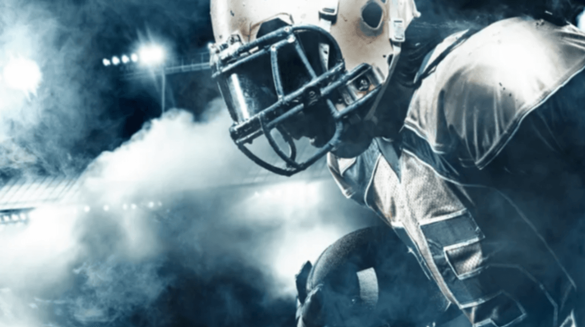 Football player runs in stadium